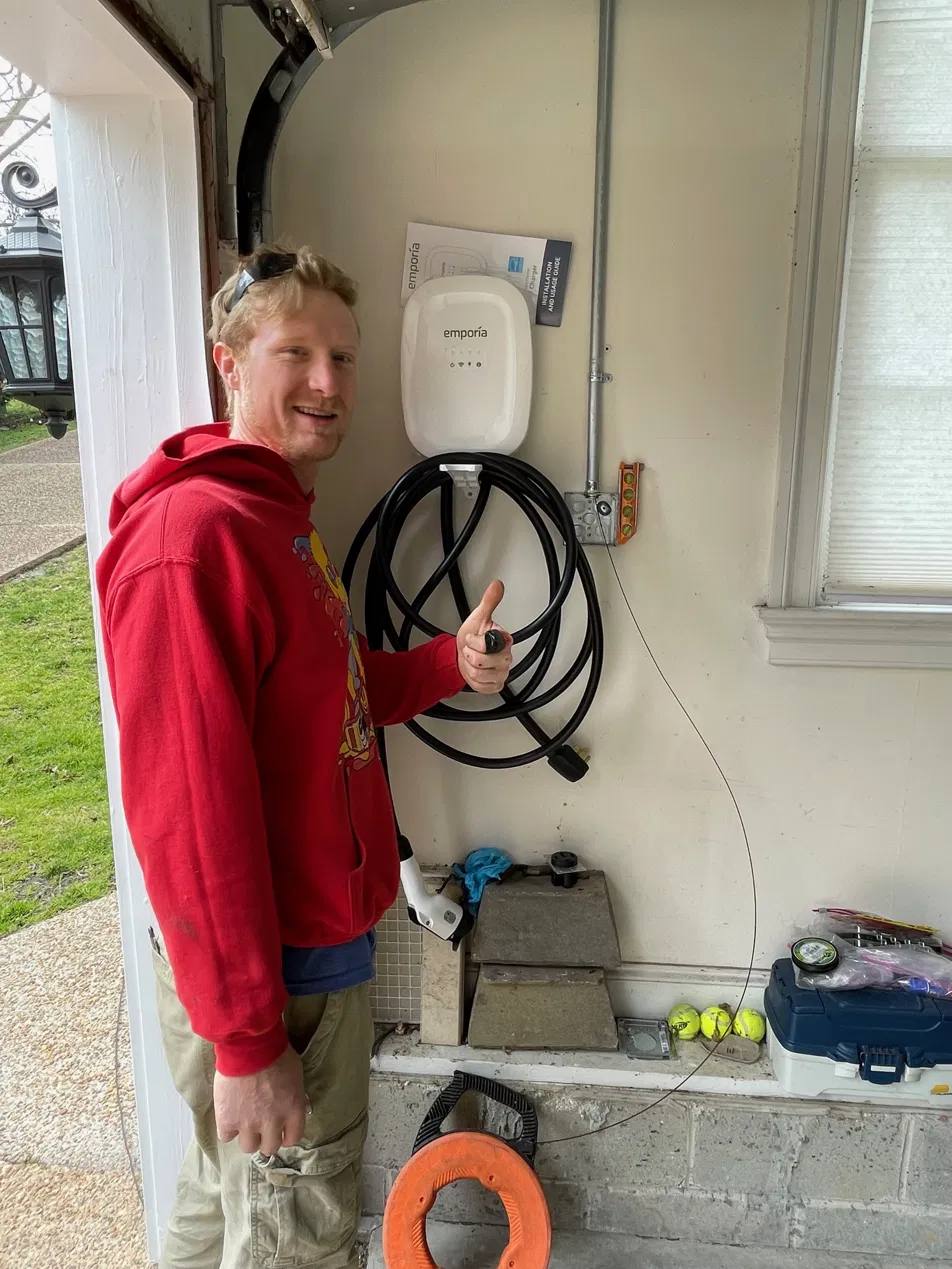 Robbie standing next to completed EV charger install